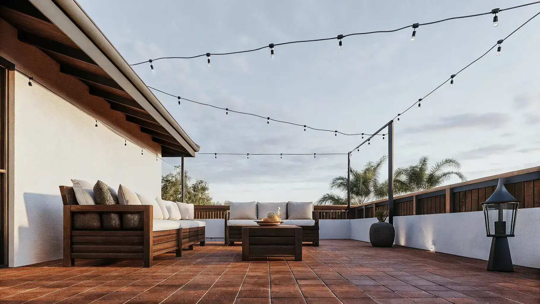 Beautiful Florida backyard patio resurfaced with warm decorative concrete overlay, string lights overhead, and tropical garden surroundings
