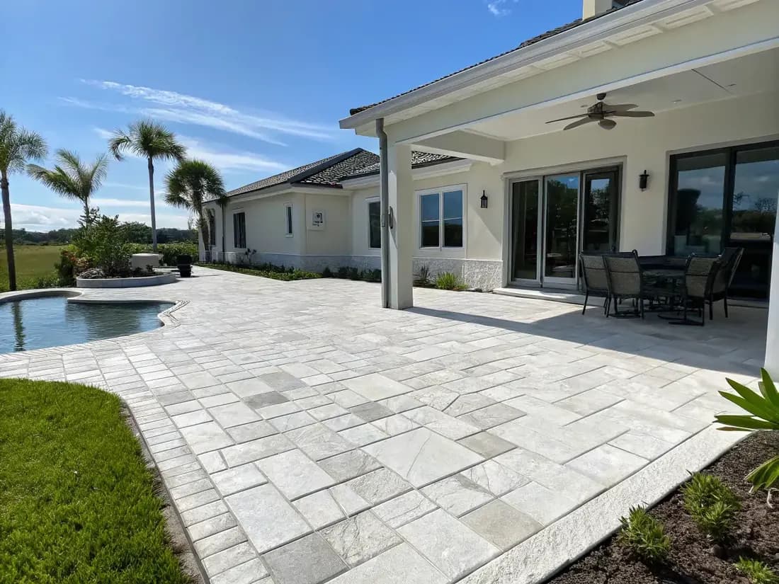 Naples FL patio resurfaced with a light flagstone stamped concrete pattern
